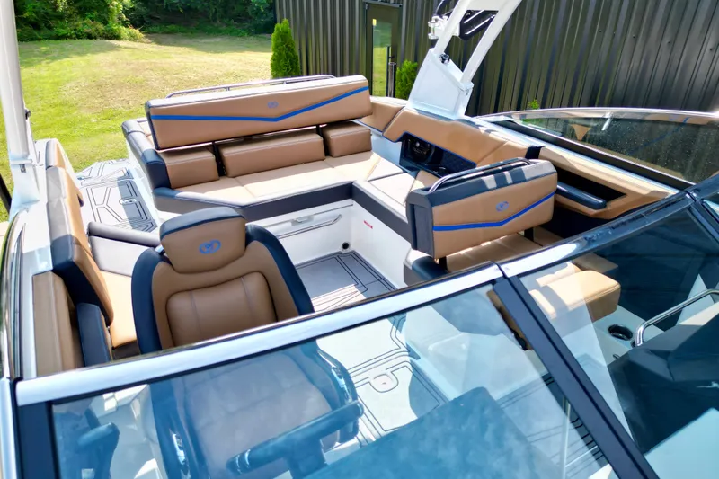 Slide: The Image of 2022 Cobalt R4 Surf boat interior with luxurious tan and blue seating. - 14
