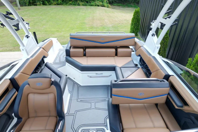 Slide: The Image of 2022 Cobalt R4 Surf boat interior with luxurious tan and black seating. - 12