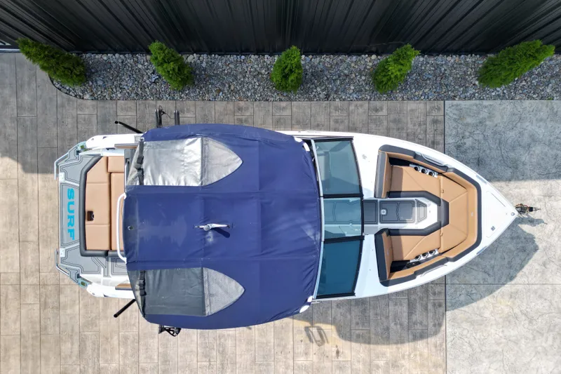 Slide: The Image of Overhead view of a 2022 Cobalt R4 Surf boat with a blue cover. - 3