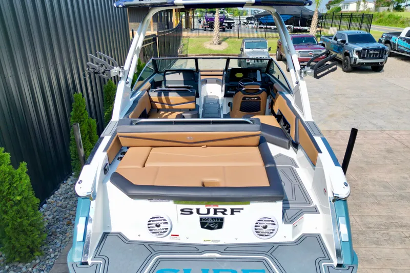 Slide: The Image of 2022 Cobalt R4 Surf boat with tan seating and sleek design. - 18