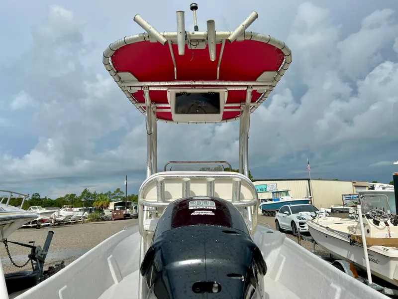 Slide: The Image of 2009 Pro-Line Pro-Lite 17 CC with a red sunshade and outboard motor. - 11