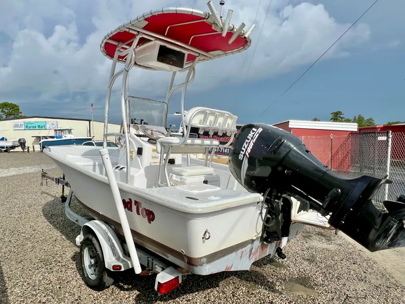 Slide: The Image of A 2009 Pro-Line Pro-Lite 17 CC with a red T-top and Suzuki outboard motor. - 13