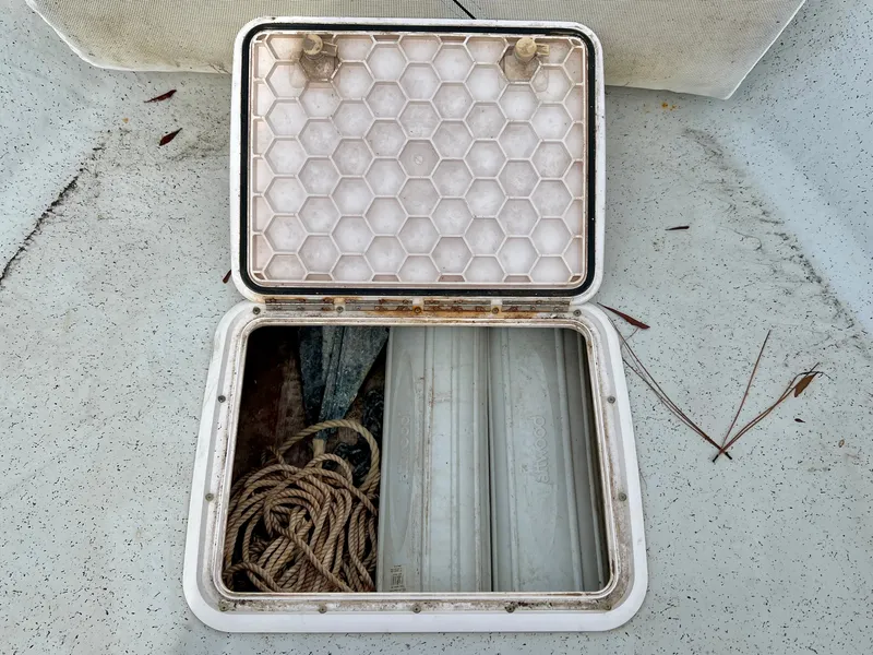 Slide: The Image of Open storage compartment on a boat with rope and anchor. - 26