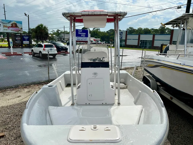 Slide: The Image of 2009 Pro-Line Pro-Lite 17 CC with center console and T-top, parked on a gravel lot. - 8