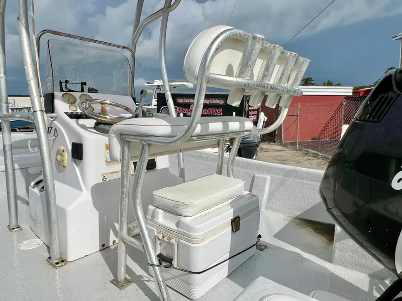 Slide: The Image of The image shows the cockpit of a 2009 Pro-Line Pro-Lite 17 CC boat with a console and seating. - 18