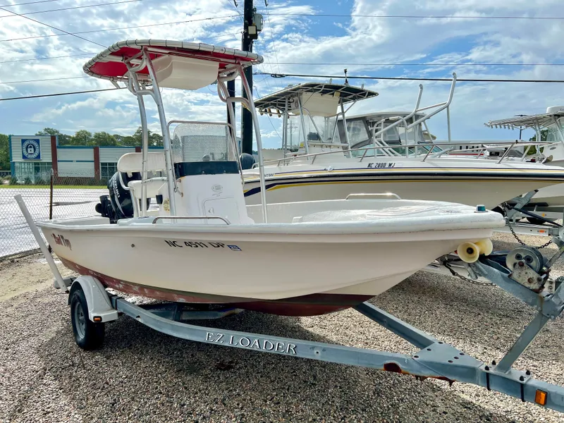 Slide: The Image of 2009 Pro-Line Pro-Lite 17 CC on a trailer, featuring a red canopy and white hull. - 1