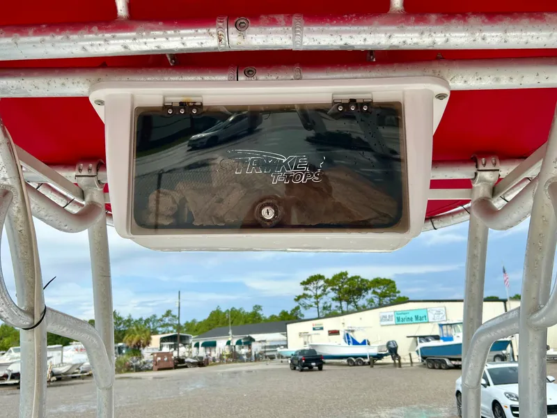 Slide: The Image of A 2009 Pro-Line Pro-Lite 17 CC with a red T-top and a storage area in the background. - 23