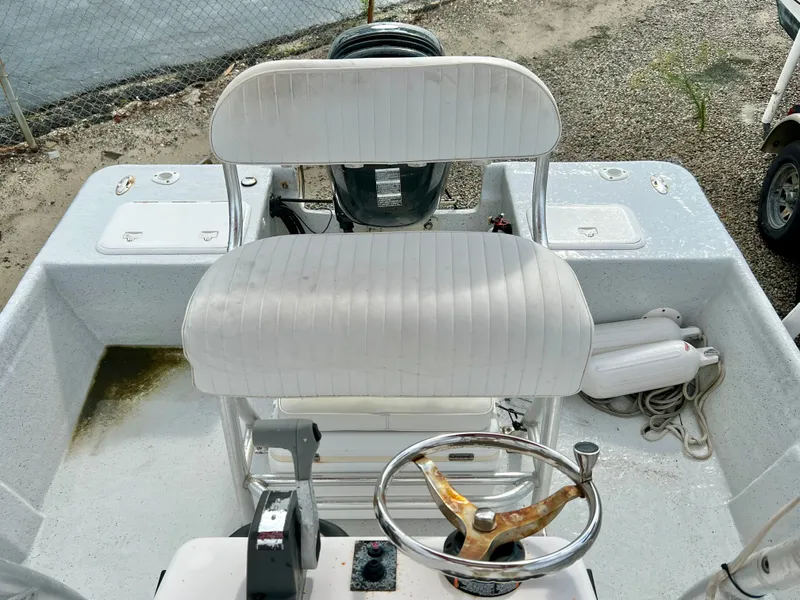 Slide: The Image of The image shows the cockpit of a 2009 Pro-Line Pro-Lite 17 CC boat with a white seat and steering wheel. - 16