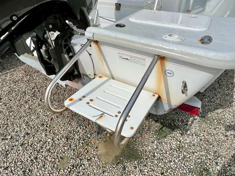 Slide: The Image of The image shows the stern of a 2009 Pro-Line Pro-Lite 17 CC boat with a swim platform. - 14
