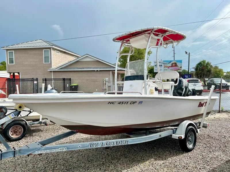 Slide: The Image of 2009 Pro-Line Pro-Lite 17 CC with red bimini top on a trailer. - 2