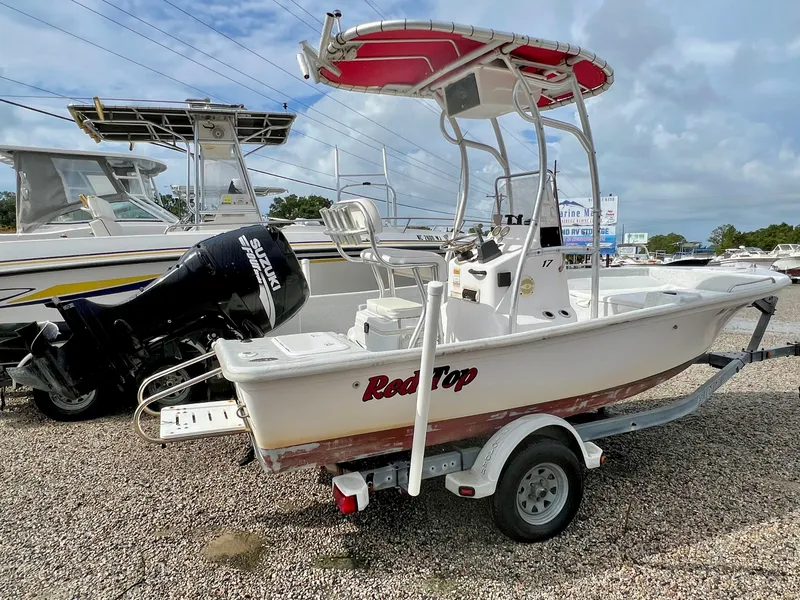 Slide: The Image of 2009 Pro-Line Pro-Lite 17 CC with red T-top and Suzuki outboard motor on a trailer. - 5