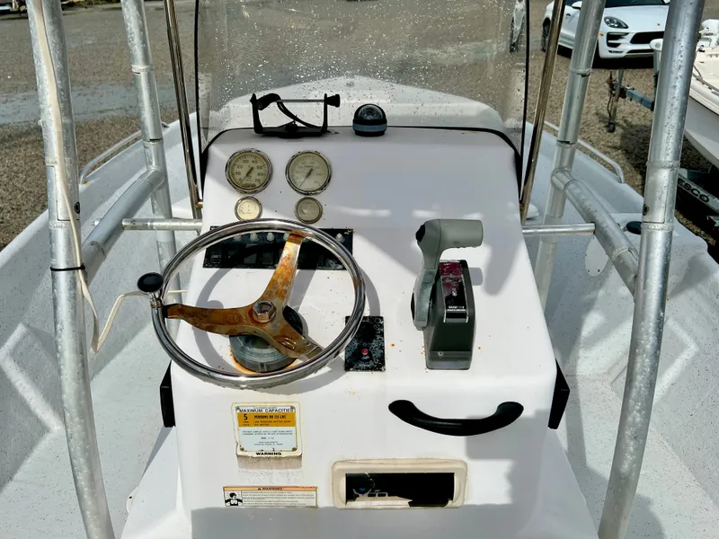 Slide: The Image of The image shows the helm of a 2009 Pro-Line Pro-Lite 17 CC boat with steering wheel and gauges. - 21