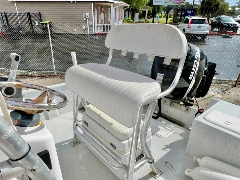 Slide: The Image of The image shows the cockpit of a 2009 Pro-Line Pro-Lite 17 CC with a white bench seat and a Suzuki outboard motor. - 20