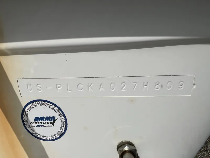 Slide: The Image of Close-up of a boat's hull identification number with NMMA certification seal. - 32