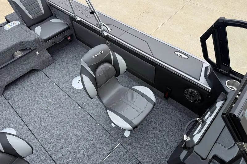 Slide: The Image of Interior of 2027 Lund 1975 Pro-V boat with gray seating and carpeted flooring. - 27