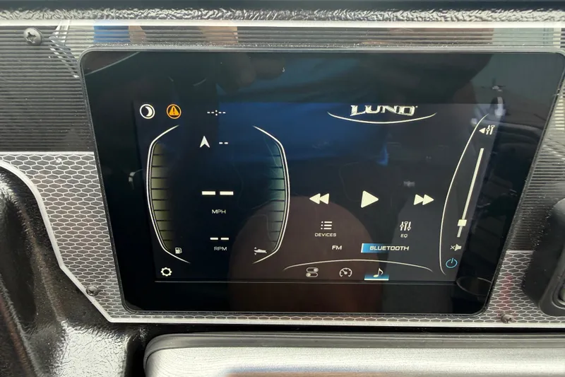 Slide: The Image of Touchscreen display of 2027 Lund 1975 Pro-V boat with navigation and audio controls. - 26