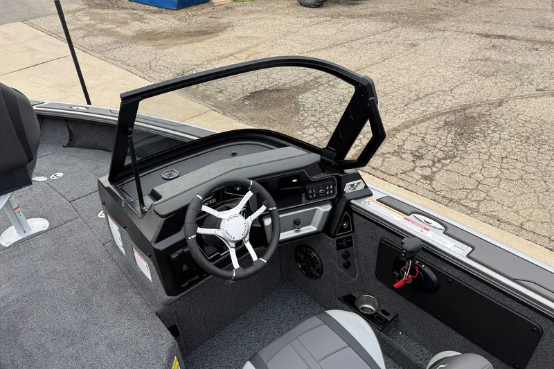 Slide: The Image of Interior view of a 2027 Lund 1975 Pro-V boat cockpit with steering wheel. - 21