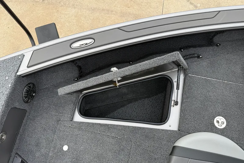 Slide: The Image of 2027 Lund 1975 Pro-V boat storage compartment with open hatch, showcasing interior design. - 14