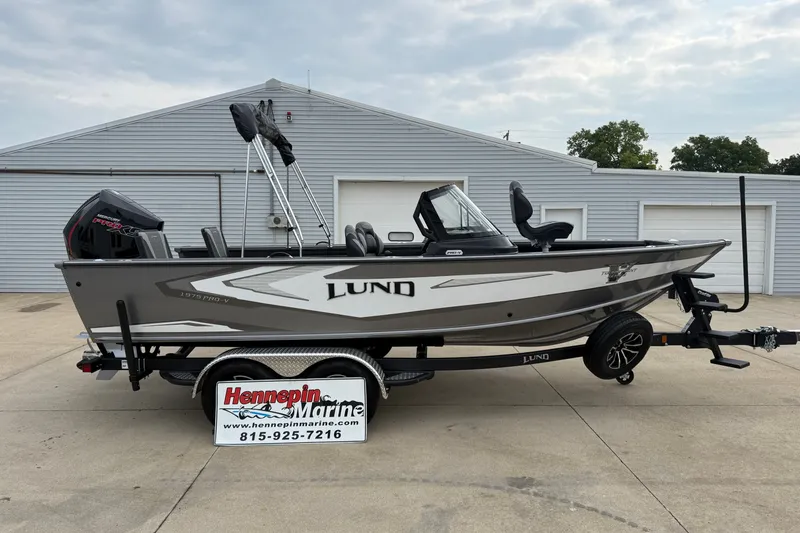 The Image of 2027 Lund 1975 Pro-V boat on trailer at Hennepin Marine dealership. - 0