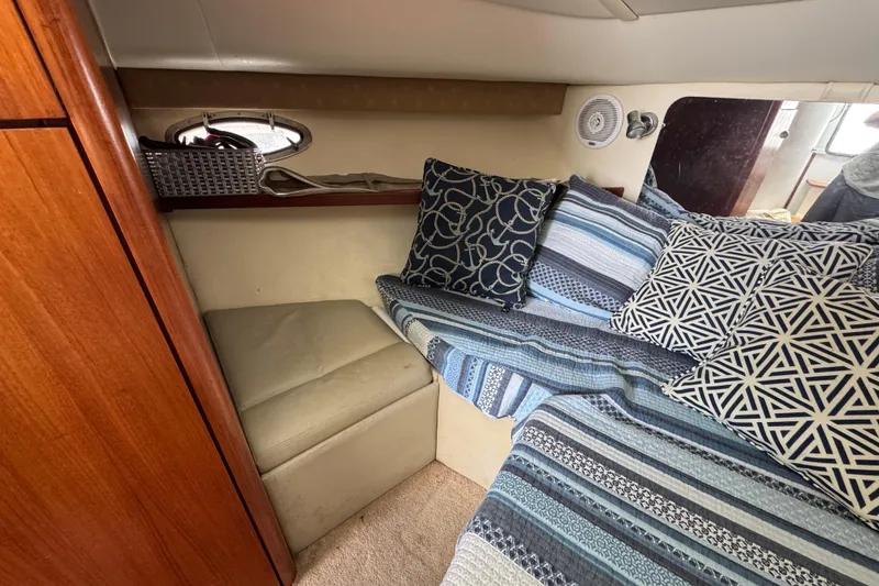 Slide: The Image of Cozy cabin interior of 1999 Tiara Yachts 2900 Open with patterned bedding and cushions. - 30