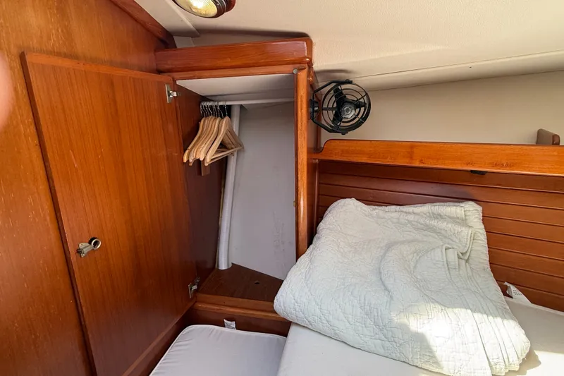Slide: The Image of Cozy cabin interior of 1988 Belliure 41 yacht with wooden closet and bedding. - 43