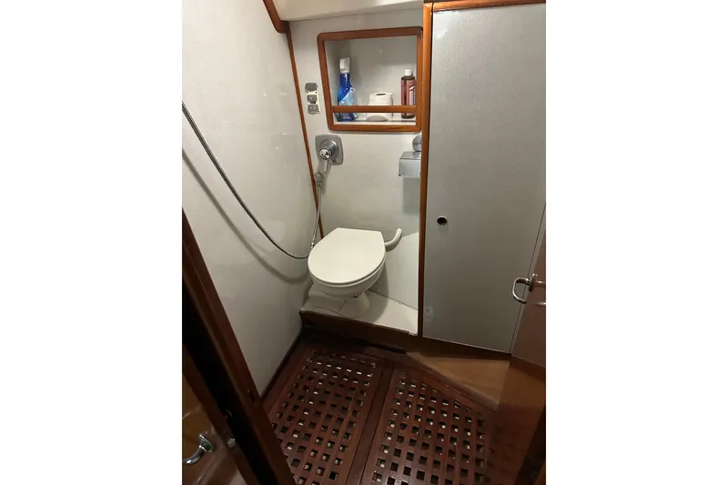 Slide: The Image of 1988 Belliure 41 yacht bathroom with wooden flooring and compact shower area. - 47