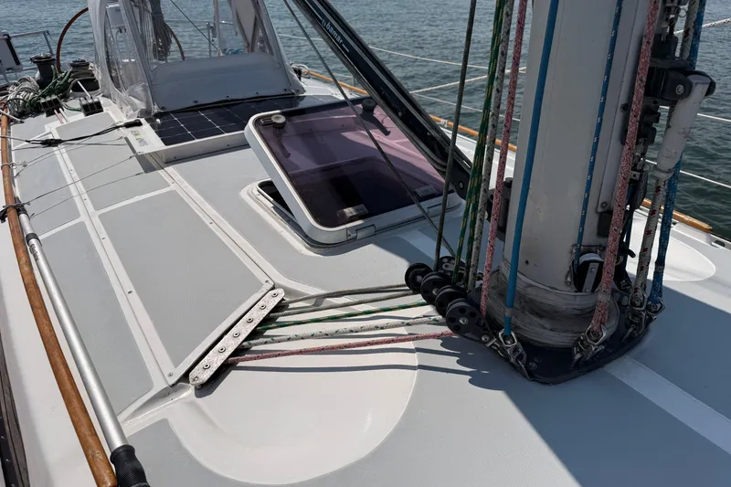 Slide: The Image of Deck of 1988 Belliure 41 sailboat with rigging and hatch, on calm water. - 56