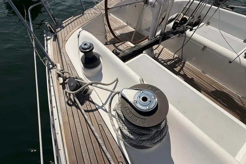 Slide: The Image of Deck of 1988 Belliure 41 sailboat with winches and ropes, showcasing teak wood finish. - 60