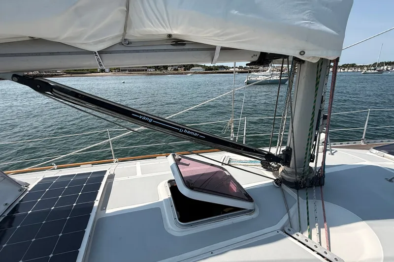 Slide: The Image of Sailboat deck of 1988 Belliure 41 with vang and solar panel, docked in marina. - 58