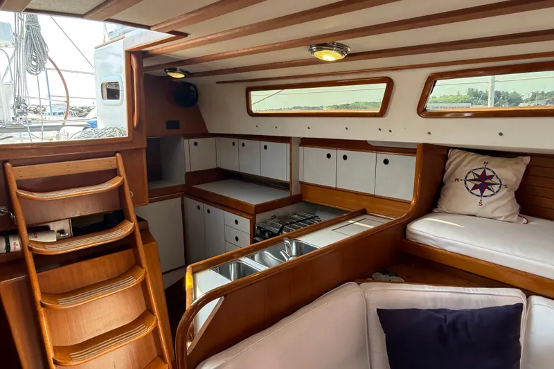 Slide: The Image of Interior of 1988 Belliure 41 yacht with wooden finishes and cozy seating area. - 30