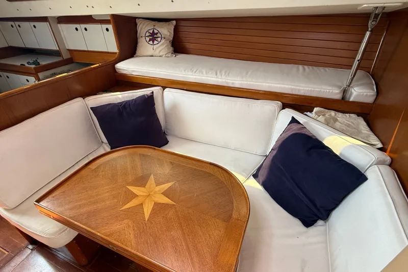 Slide: The Image of Cozy interior of 1988 Belliure 41 yacht with white seating and wooden table. - 17