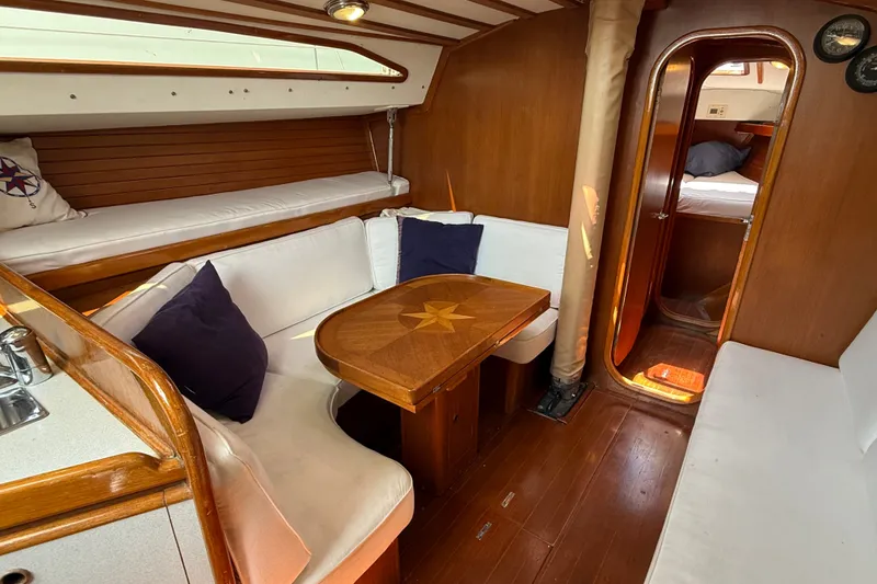 Slide: The Image of Interior of 1988 Belliure 41 yacht with wooden furnishings and cozy seating area. - 15