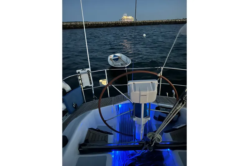 Slide: The Image of 1988 Belliure 41 sailboat cockpit with illuminated blue lighting at dusk. - 89