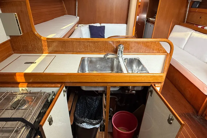 Slide: The Image of Interior of 1988 Belliure 41 yacht featuring kitchen sink, stove, and seating area. - 37
