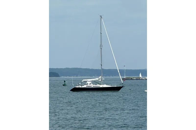 Slide: The Image of Sailboat on calm water, 1988 Belliure 41 model, with distant shoreline. - 13