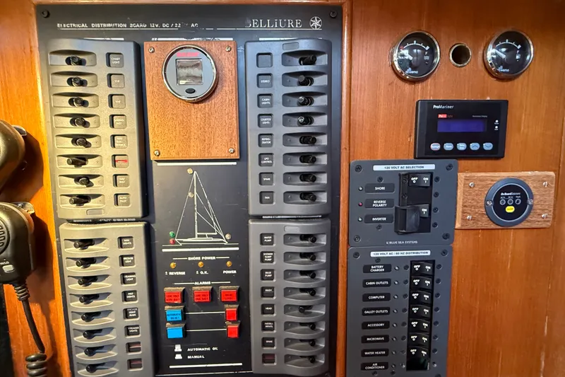 Slide: The Image of Electrical control panel on a 1988 Belliure 41 yacht, featuring switches and gauges. - 28