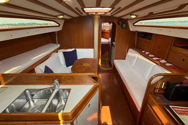 Slide: The Image of Interior of 1988 Belliure 41 yacht with wooden finish and cozy seating area. - 21