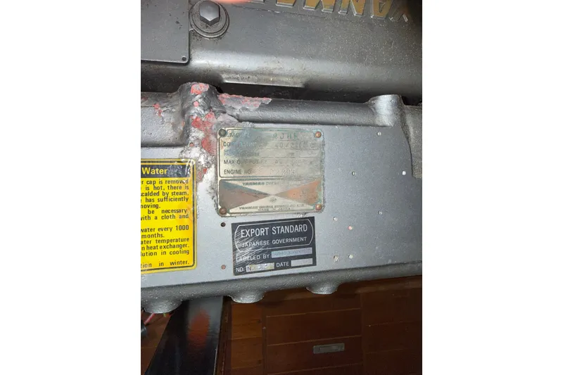 Slide: The Image of Engine compartment of a 1988 Belliure 41 yacht with visible labels and instructions. - 88