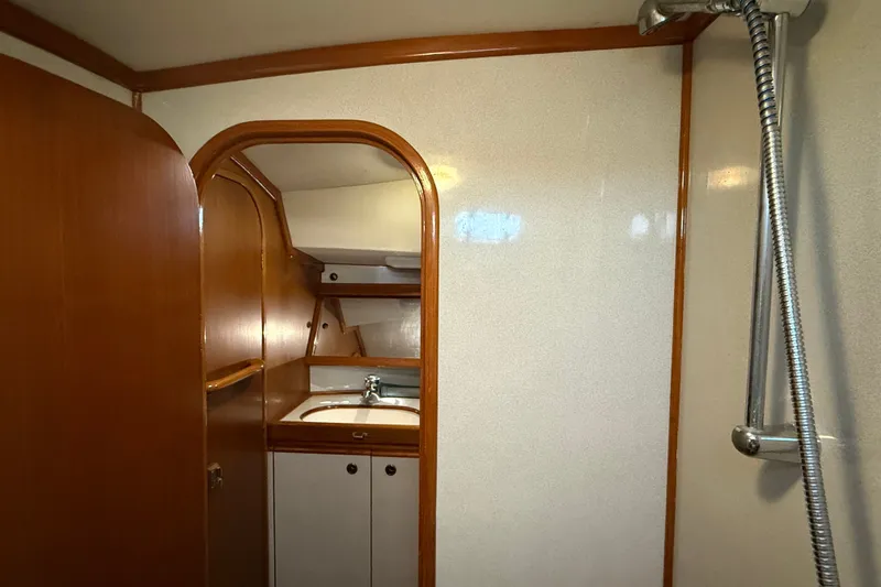Slide: The Image of Interior of 1988 Belliure 41 yacht bathroom with wooden cabinetry and shower. - 50