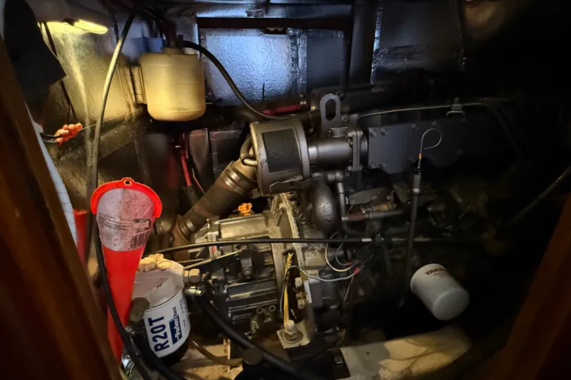 Slide: The Image of Engine room of a 1988 Belliure 41 yacht, featuring mechanical components and maintenance tools. - 86