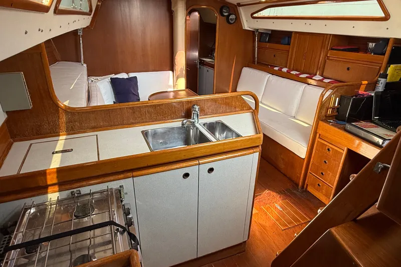 Slide: The Image of Interior of 1988 Belliure 41 yacht with wooden finish and compact kitchen area. - 32