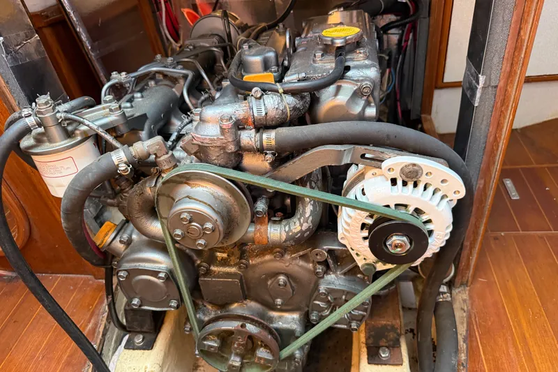 Slide: The Image of Engine of a 1988 Belliure 41 yacht, showcasing mechanical components and belts. - 81