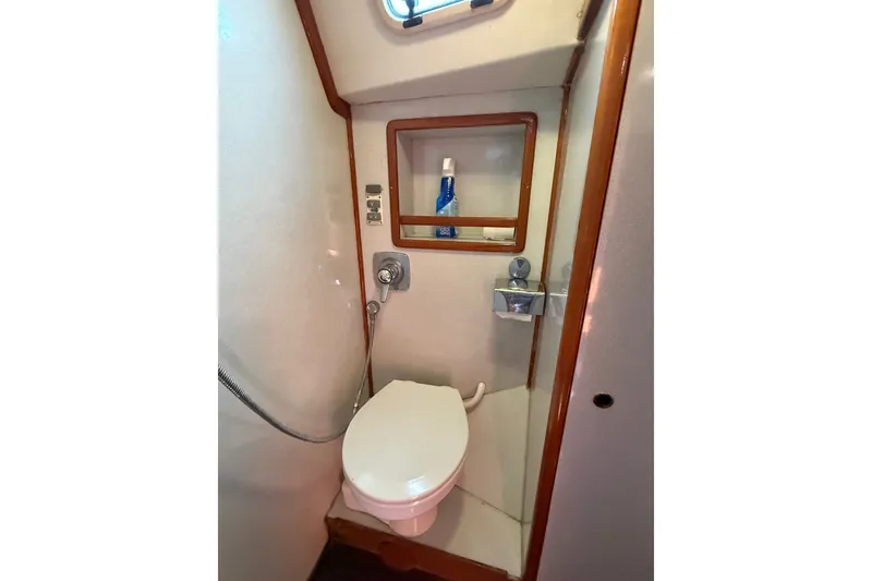 Slide: The Image of Compact bathroom in 1988 Belliure 41 yacht with toilet and showerhead. - 46