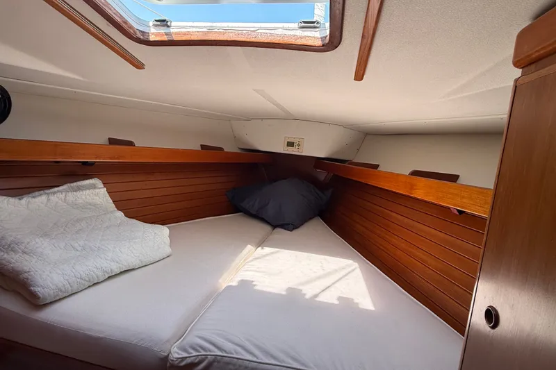 Slide: The Image of Cozy cabin interior of 1988 Belliure 41 yacht with wooden paneling and bedding. - 40