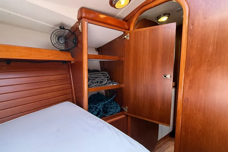 Slide: The Image of Interior of 1988 Belliure 41 yacht with wooden cabinetry and storage shelves. - 42