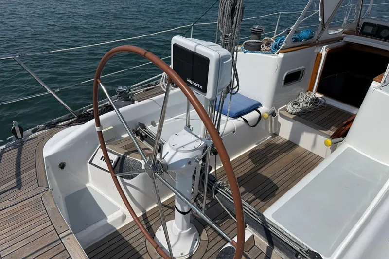 Slide: The Image of Cockpit of 1988 Belliure 41 sailboat with wooden steering wheel and navigation equipment. - 70