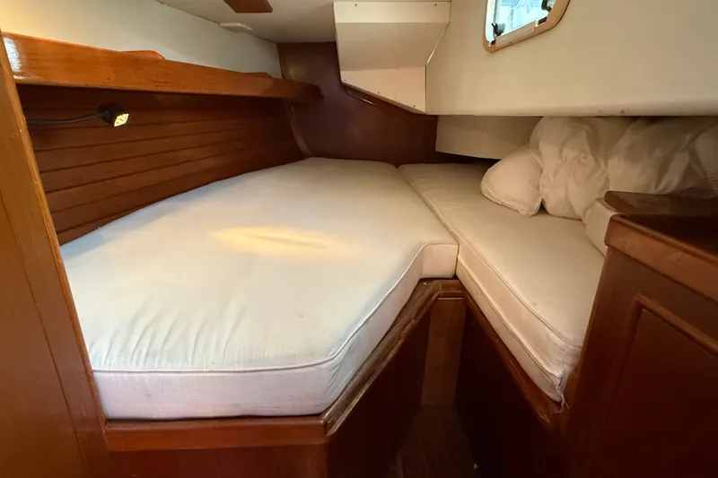 Slide: The Image of Cozy cabin interior of 1988 Belliure 41 yacht with wooden accents and white cushions. - 52