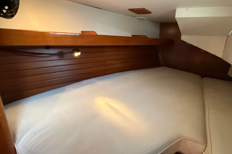 Slide: The Image of Cozy cabin interior of 1988 Belliure 41 yacht with wooden paneling and soft lighting. - 53