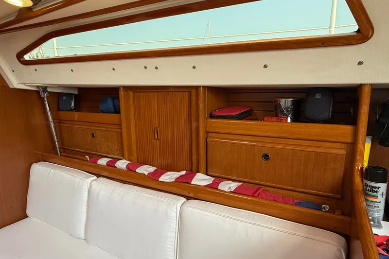 Slide: The Image of Interior of 1988 Belliure 41 yacht with wooden cabinetry and white seating. - 19
