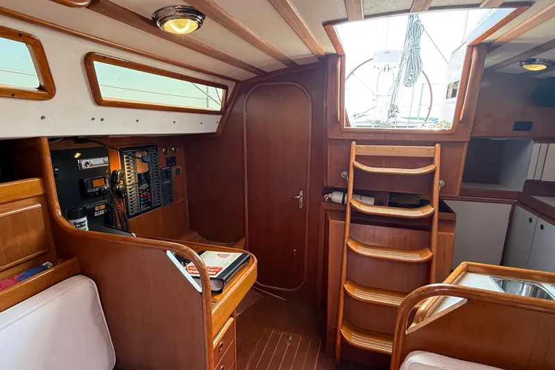 Slide: The Image of Interior of 1988 Belliure 41 sailboat with wooden finish and navigation equipment. - 23